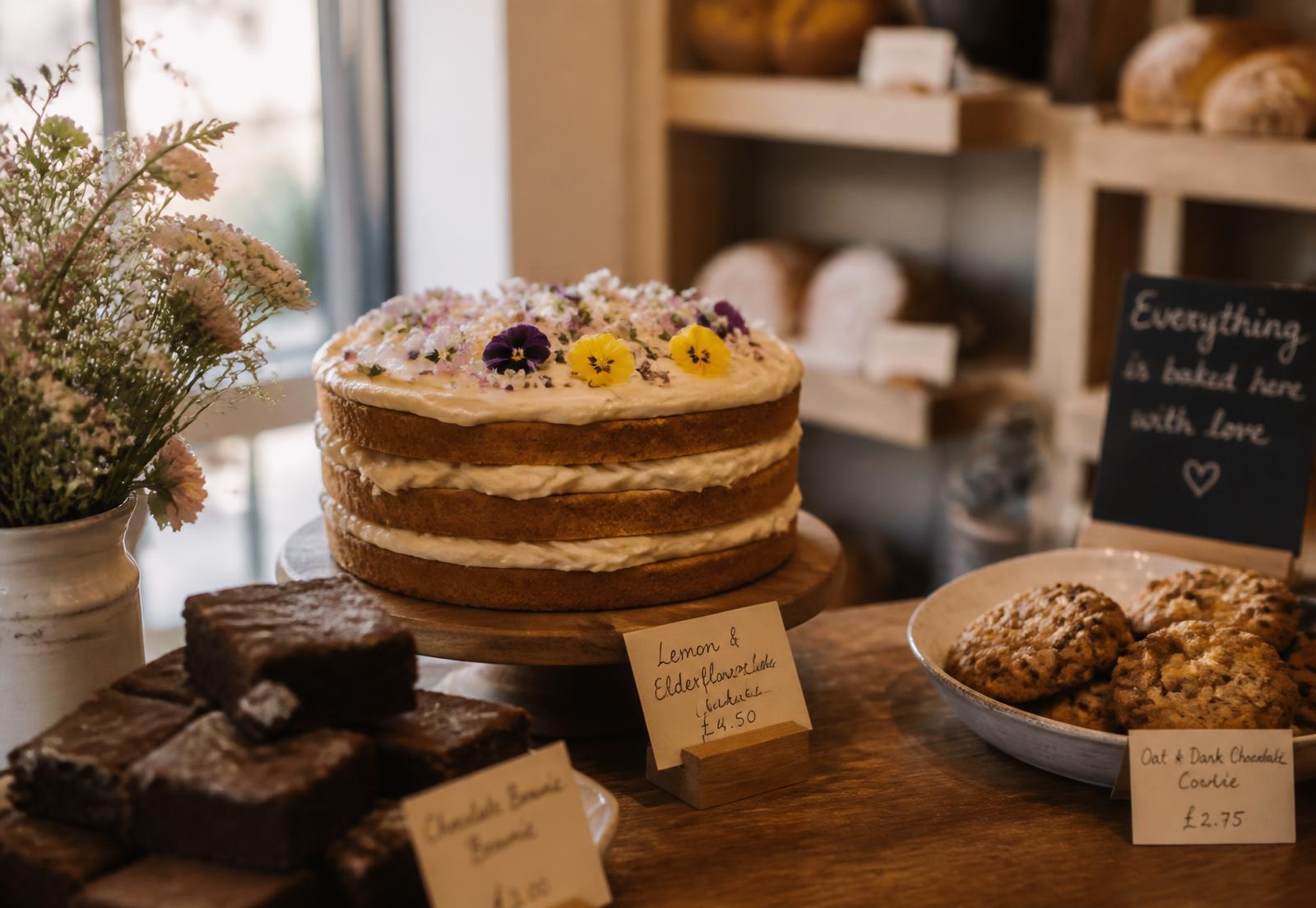 Freshly baked layer cake, brownies and cookies on a bakery counter